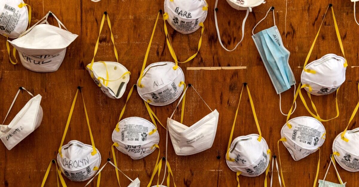 Protective masks bearing the names of medical staffers and nurses are pictured pinned to a wall on April 2, 2020 at the operative field hospital for coronavirus patients, financed by US evangelical Christian disaster relief NGO Samaritans Purse, outside the Cremona hospital, Lombardy. - Fully operational, the structure consist of 15 tents, 60 beds, 8 of which in intensive care.