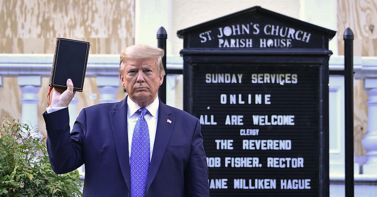 US President Donald Trump holds up a Bible outside of St John's Episcopal church across Lafayette Park in Washington, DC on June 1, 2020. - US President Donald Trump was due to make a televised address to the nation on Monday after days of anti-racism protests against police brutality that have erupted into violence. The White House announced that the president would make remarks imminently after he has been criticized for not publicly addressing in the crisis in recent days.