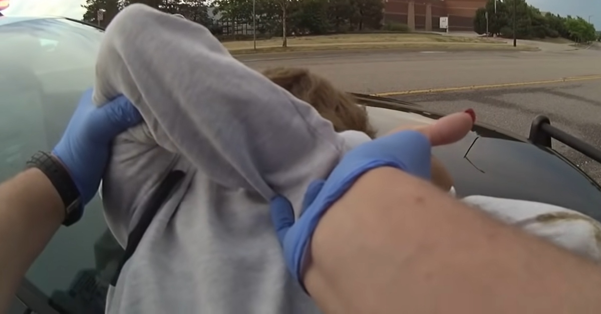 Austin Hopp twists Karen Hopp's arm during a violent arrest.