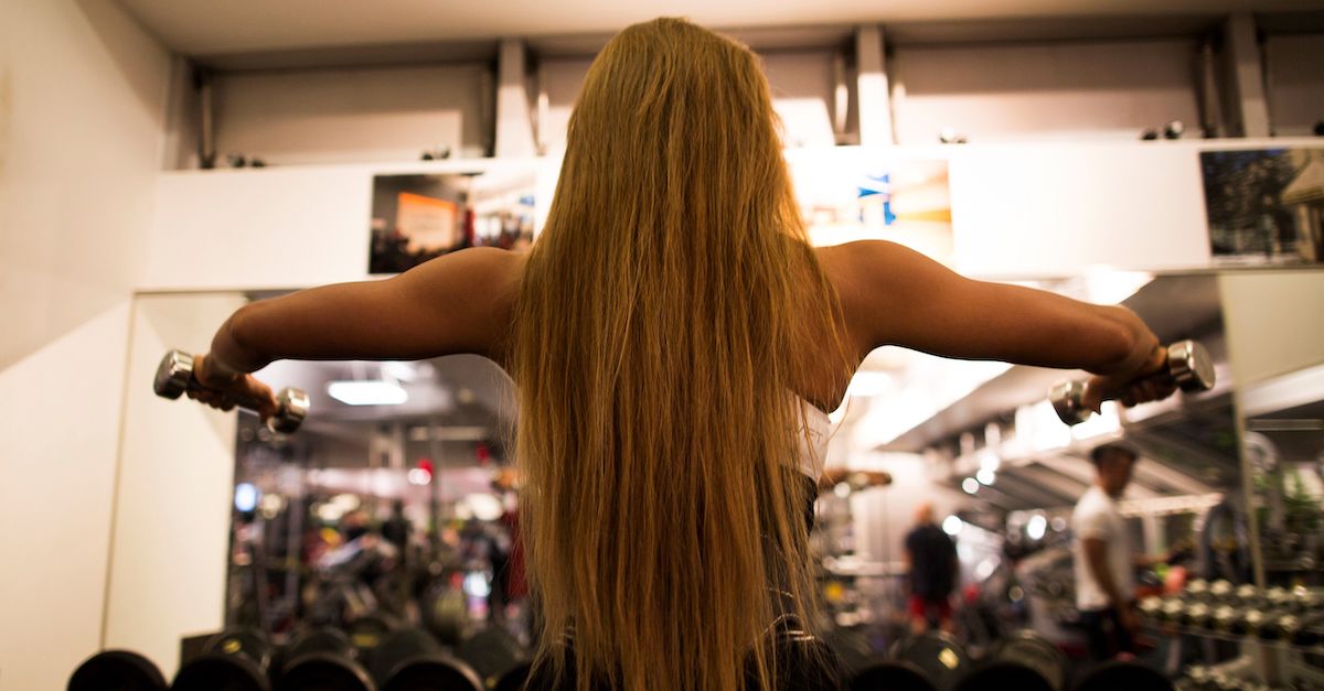 A stock photo shows a woman working out in a gym.