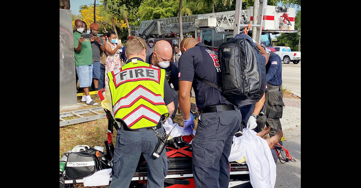 Lyndsey Jane Kennedy sits on a stretcher after being rescued.