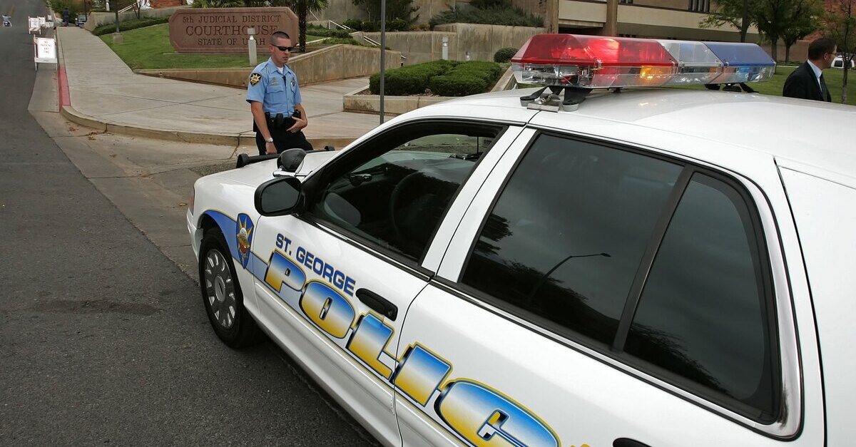 A St. George Police Officer stands in front of a courthouse