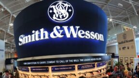 Convention goers look at weapons at the Smith and Wesson booth