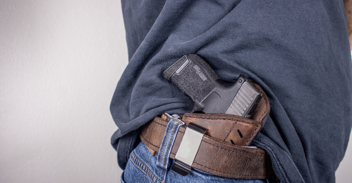 A man open-carrying a pistol