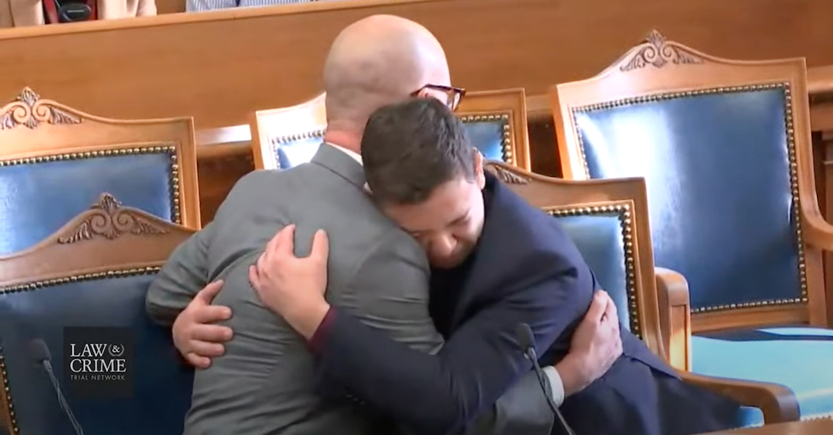 Attorney Corey Chirafisi (left) comforts Kyle Rittenhouse on Friday, Nov. 19, 2021, in Kenosha, Wis. courtroom. Rittenhouse collapsed as his not guilty verdicts were read. (Image via the Law&Crime Network.)