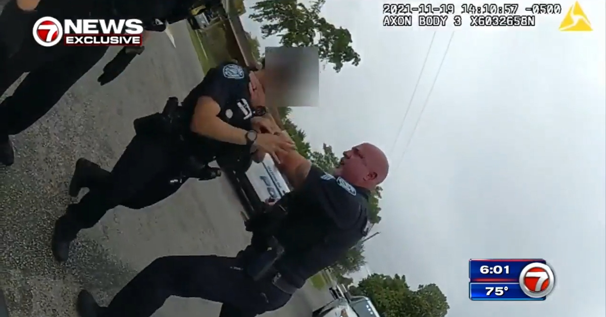 Sgt. Christopher Pullease (right) grabbing unidentified female officer in video dated Nov. 19.