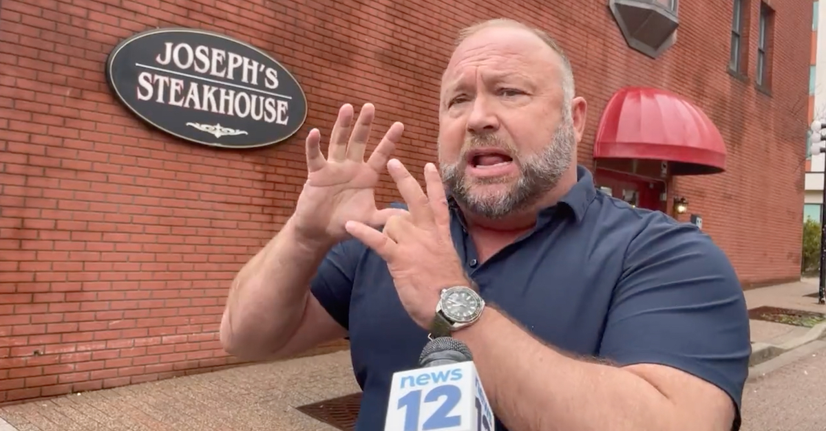 Alex Jones spoke to a local reporter from News12 Connecticut while on an apparent lunch break during a multi-day deposition in Bridgeport, Conn., on April 6, 2022. (Image via News12/Twitter video screengrab.)