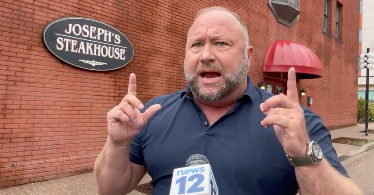 Alex Jones spoke to a local reporter from News12 Connecticut while on an apparent lunch break during a multi-day deposition in Bridgeport, Conn., on April 6, 2022. (Image via News12/Twitter video screengrab.)