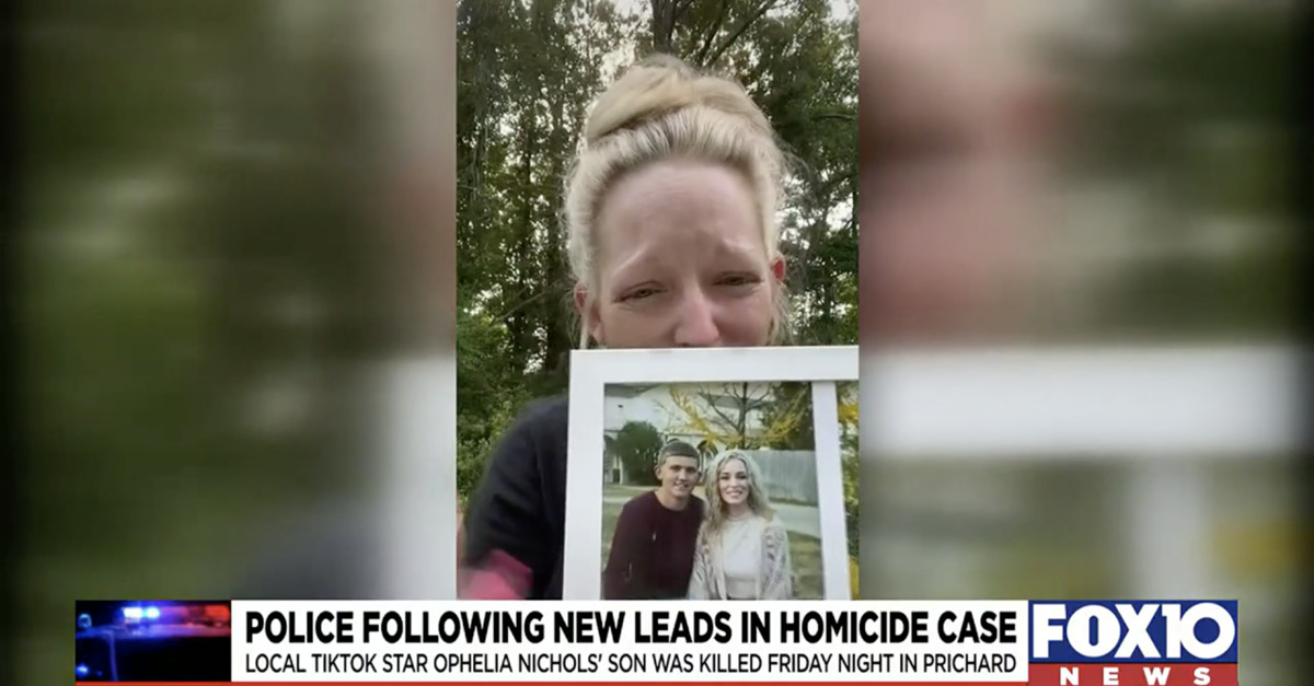 Ophelia Nichols holding a picture of her slain son