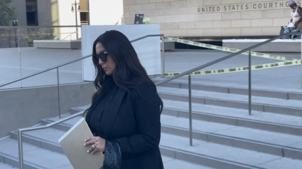 A woman in black who is Vanessa Bryant walks out of the federal courthouse in downtown Los Angeles