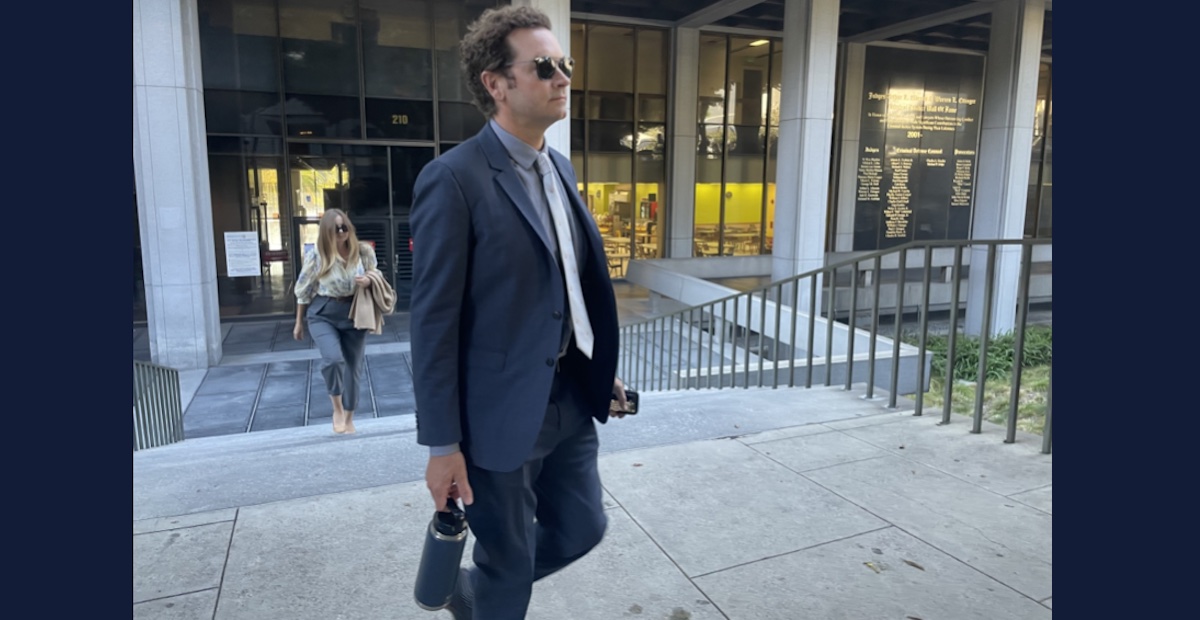 A man in a shirt and a tie who was in the That 70s Show walks away from a courthouse