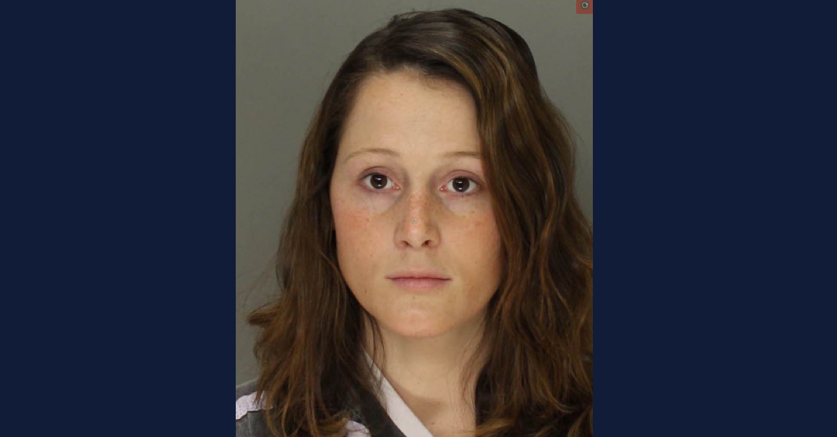 Danielle Bewley has long brown hair and is looking directly into the camera in this booking photo.