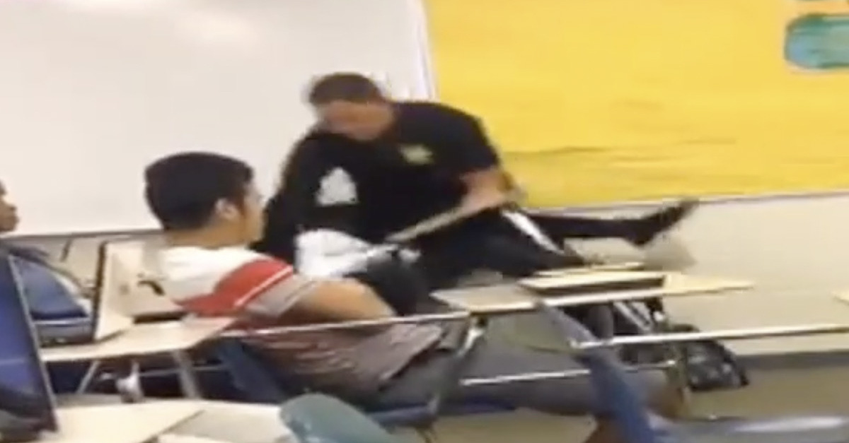 A school resource officer is shown grabbing student Niya Kenny out of a classroom.
