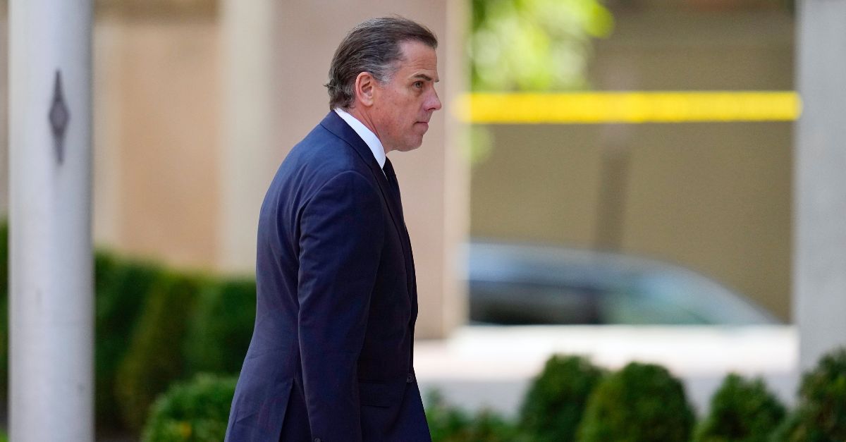 Hunter Biden is seen in profile wearing a blue suit jacket as he walks into a courtroom for his plea agreement hearing.