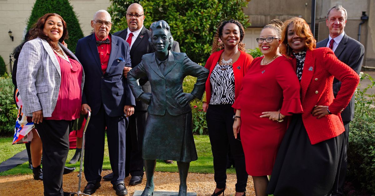 The family of Henrietta Lacks appear around a statue built in her honor. 