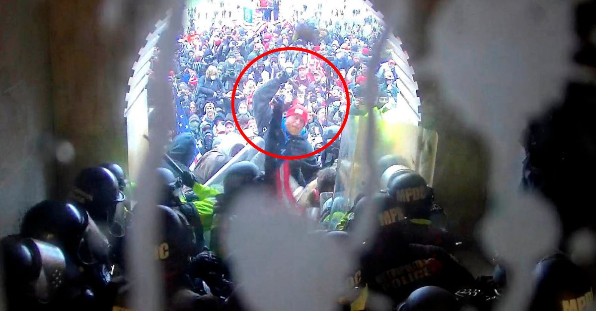 In this image from U.S. Capitol Police security video, released and annotated by the Justice Department in the Statement of Facts supporting an arrest warrant, Shane Jenkins, circled in red, is seen holding an object near the Lower West Terrace tunnel at the U.S. Capitol on Jan. 6, 2021, in Washington. Jenkins, a Texas man who attacked the U.S. Capitol with a metal tomahawk and is now the face of a website selling merchandise portraying jailed rioters as “political prisoners”, was sentenced on Friday, Oct. 6, 2023, to seven years behind bars. (Justice Department via AP)