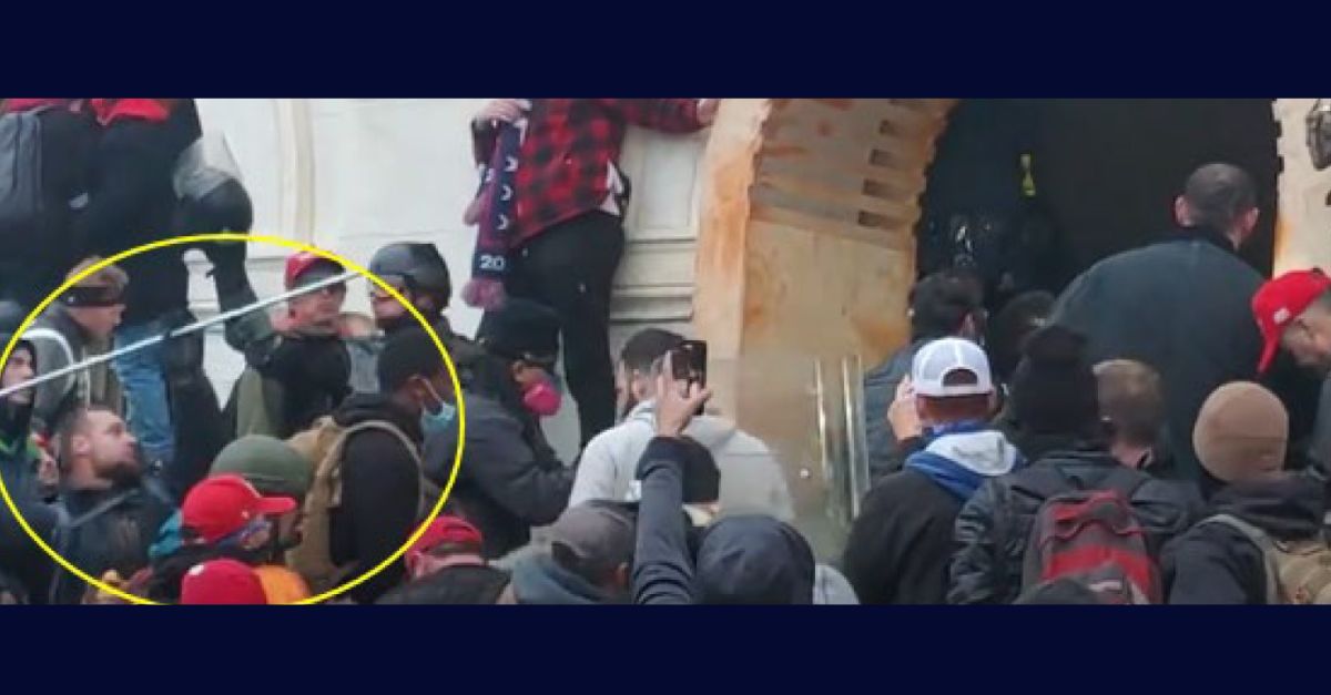 Justice Department provided photo shows accused Jan. 6 rioter Joshua Atwood preparing to hurl a metal pole toward officers inside the tunnel of the U.S. Capitol's lower west terrace. 