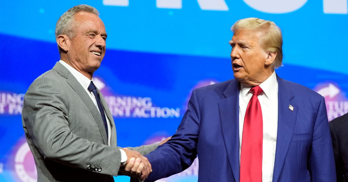 Republican presidential nominee former President Donald Trump shakes hands with Robert F. Kennedy Jr., at a Turning Point Action campaign rally, Wednesday, Oct. 23, 2024, in Duluth, Ga. (AP Photo/Alex Brandon)