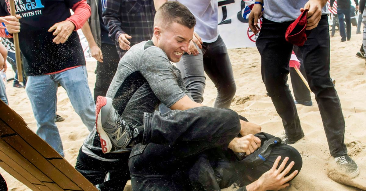 Left: Robert Paul Rundo, of Huntington Beach, California, holds down and punches a counter-protester at a political rally at Bolsa Chica State Beach in Huntington Beach, Calif. March 25, 2017. (Mindy Schauer/The Orange County Register via AP)