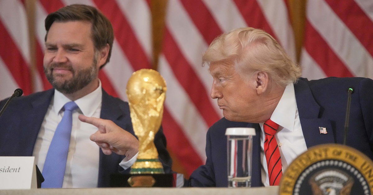 President Donald Trump gestures past Vice President JD Vance during a FIFA task force meeting on the 2026 FIFA World Cup in the East Room of the White House, Tuesday, May 6, 2025, in Washington (AP Photo/Mark Schiefelbein).