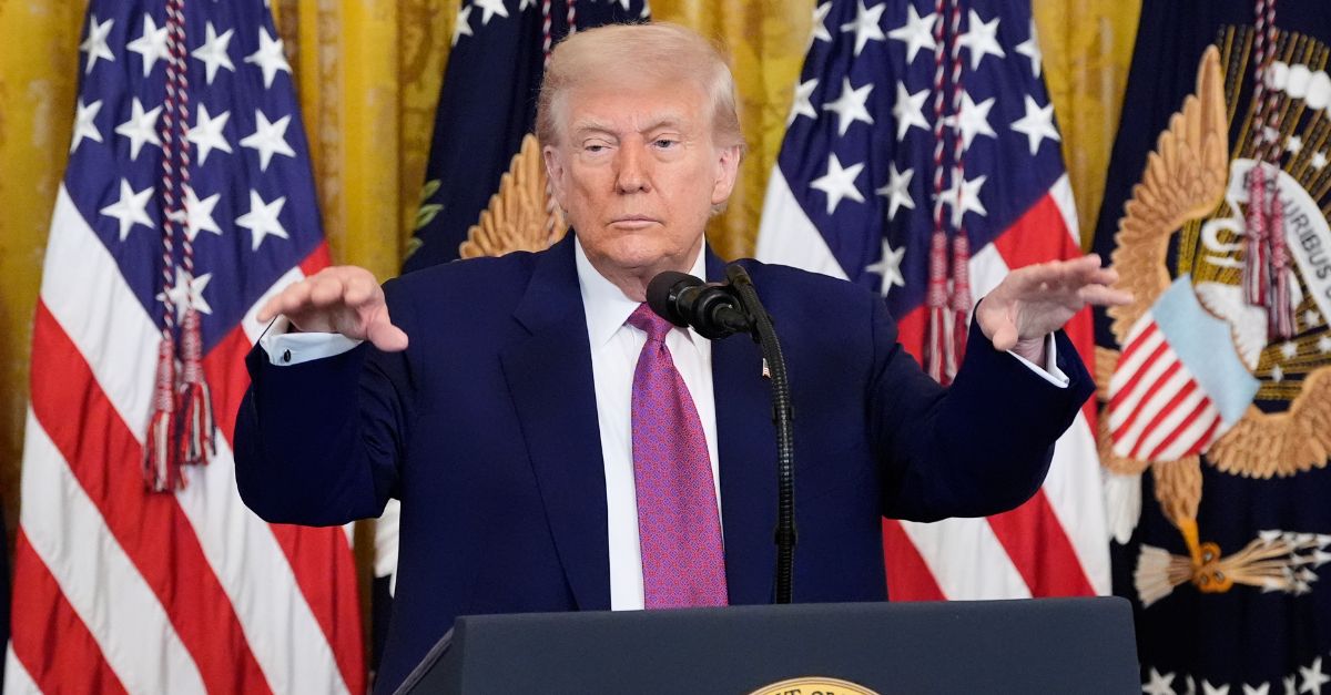 Donald Trump gestures with both hands.