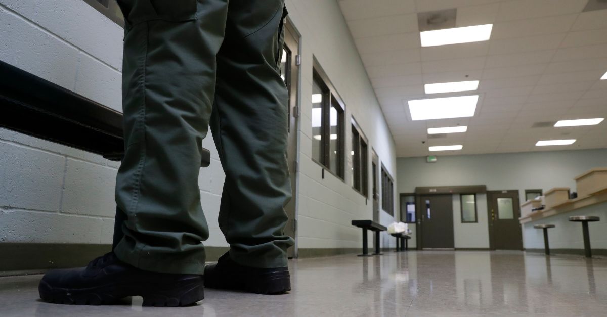 A guard stands at the Adelanto ICE Processing Center in Adelanto, Calif.
