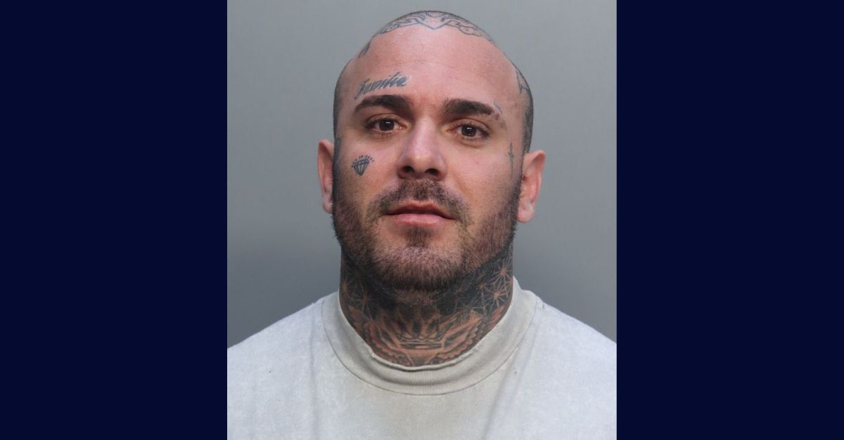 Christian Jesus Arias Acosta appears in a booking photo.