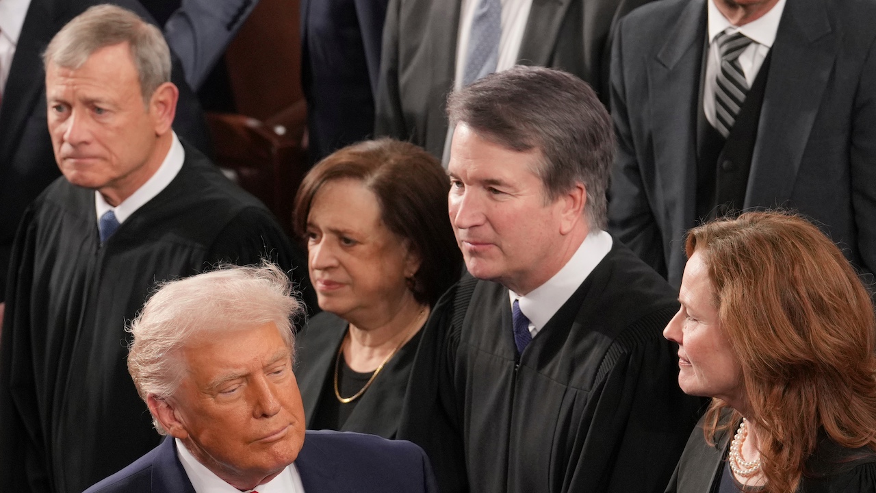 President Donald Trump walks past Chief Justice John Roberts at State of the Union.